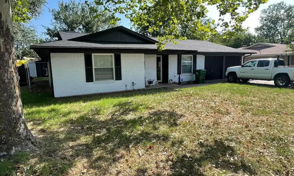 Professional roofing crew working on a residential roof in Camp Swift